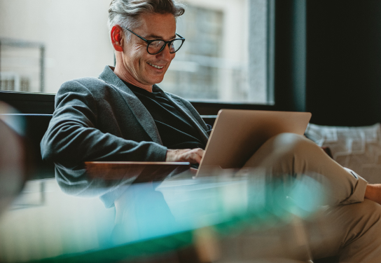 Business - Digital Accelerator - Chamber of Commerce Image of a man sitting on a sofa on his laptop