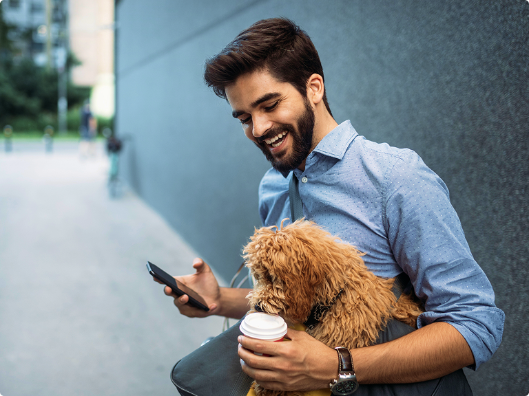 Data Clock - 60 min of you time Man using his mobile phone while his dog tries to get a sip of his coffee