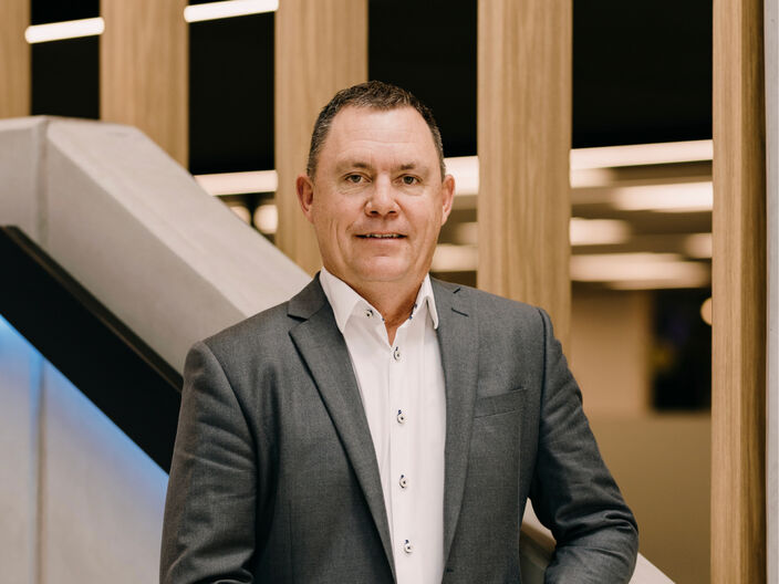 Image of the 2degrees CEO Mark Callander looking at the camera, standing on the head office stairwell.